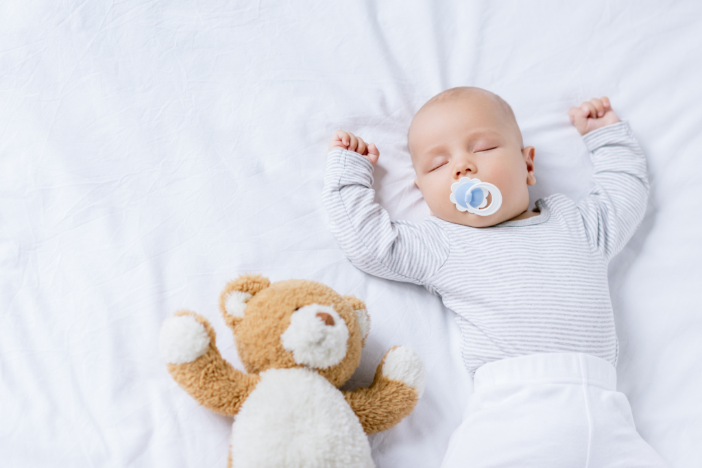 baby sleeping with Teddy bear