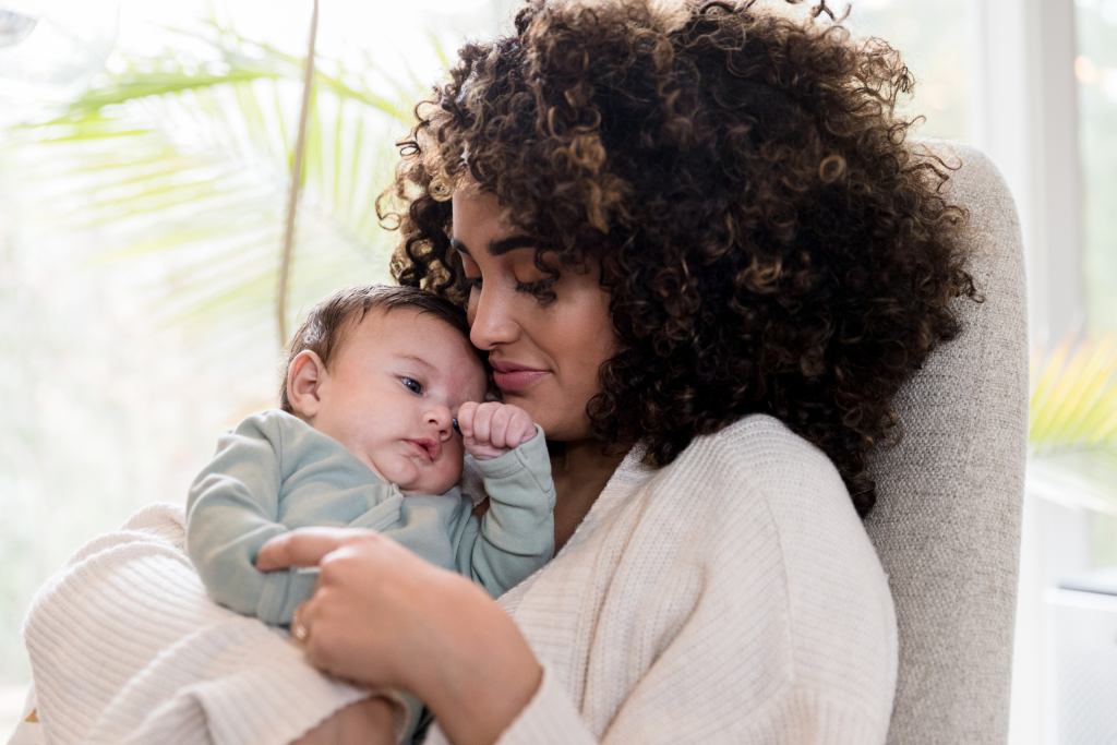 baby lying in mother's arm