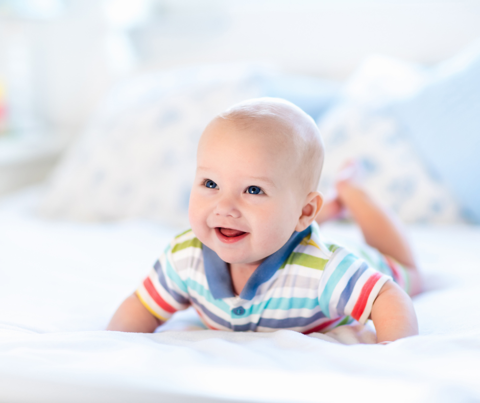a smiling baby wearing colorful clothing