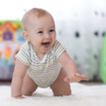 a happy baby in a safe crawling environment